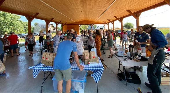 Visitors browsing tables at the Saturday market
