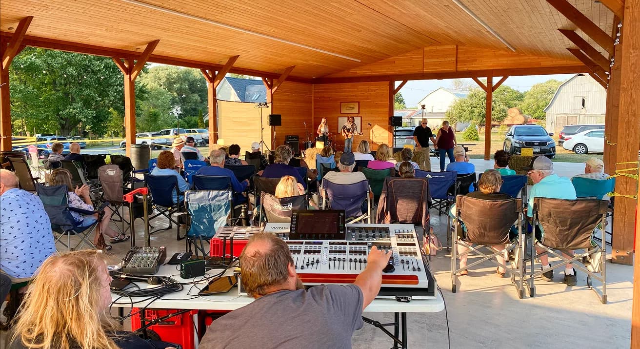 Audience watching a band perform under the Pavilion
